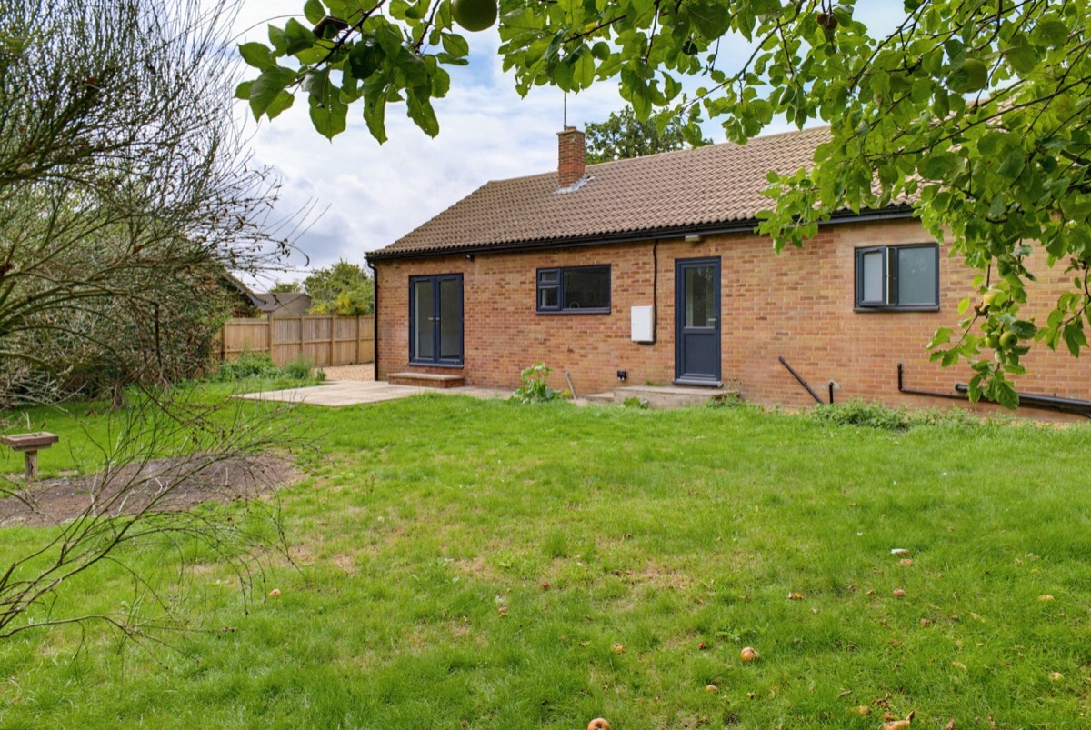 Bungalow rear elevation seen across the garden