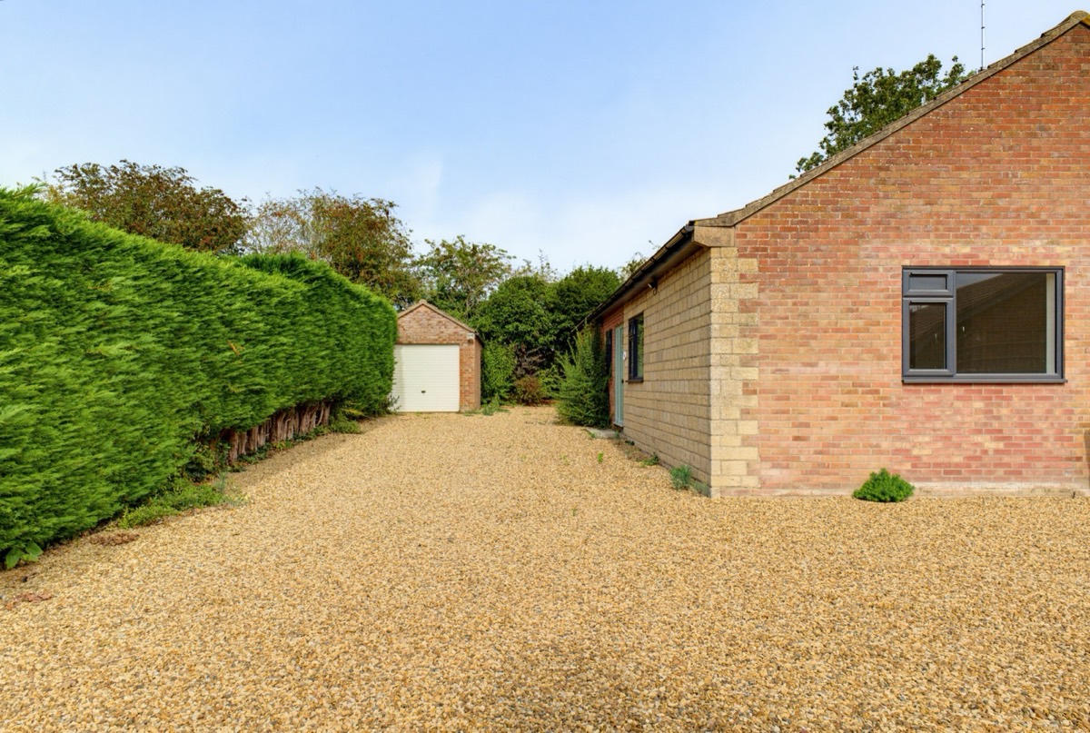 Bungalow side elevation with gravel driveway