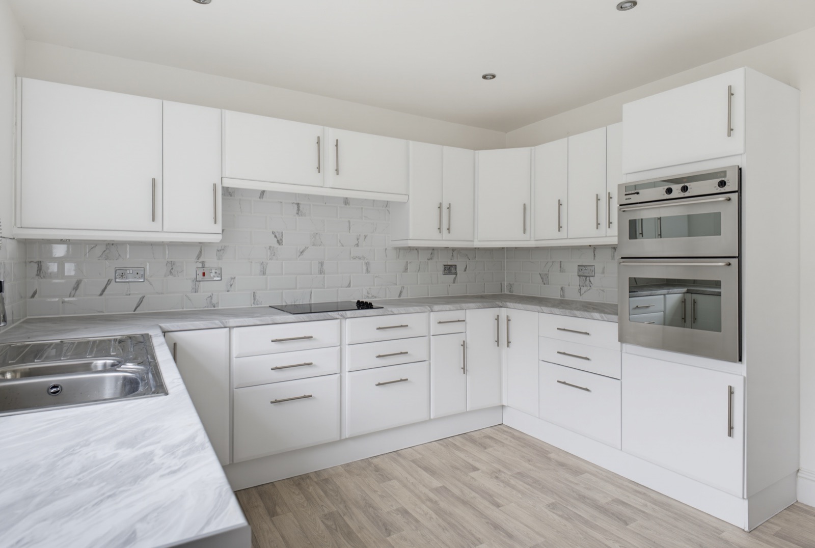 White fitted kitchen with marble-effect worktops
