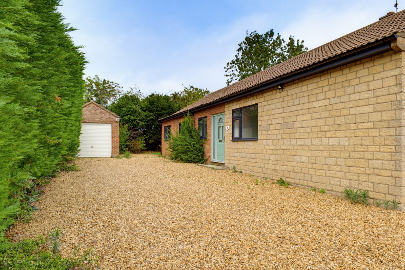 Bungalow exterior with gravel driveway